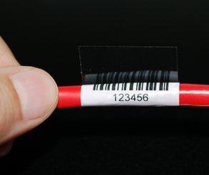 Barcoded cable label wrapped around a red wire