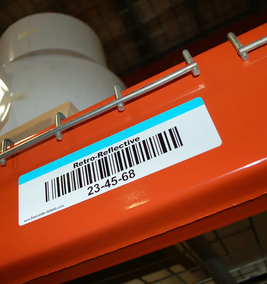 Retro-reflective barcode label on a warehouse rack for long distance scanning 