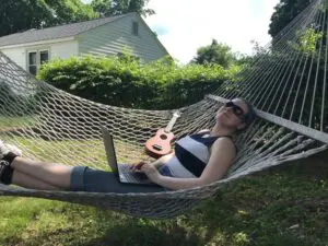 label expert briana laying outside in a hammock 