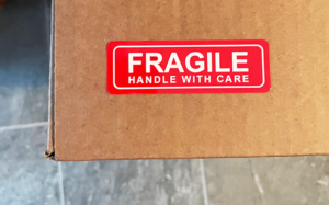 Red Fragile label on cardboard box