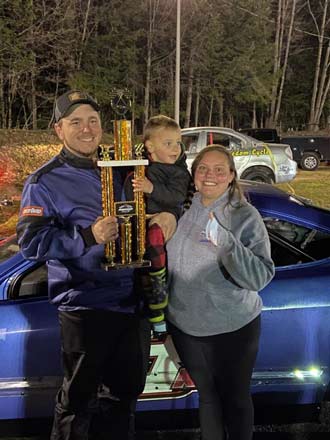 Label Expert Cecilia and Family in front of race car