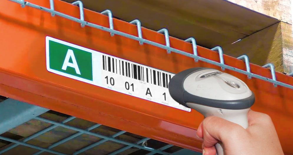 Orange warehouse rack with a printed barcode label getting scanned