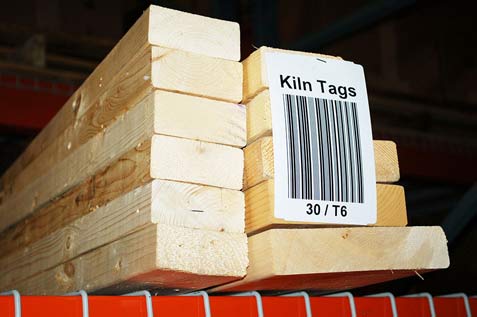 barcode tag attached to stacks of wooden lumber in a warehouse