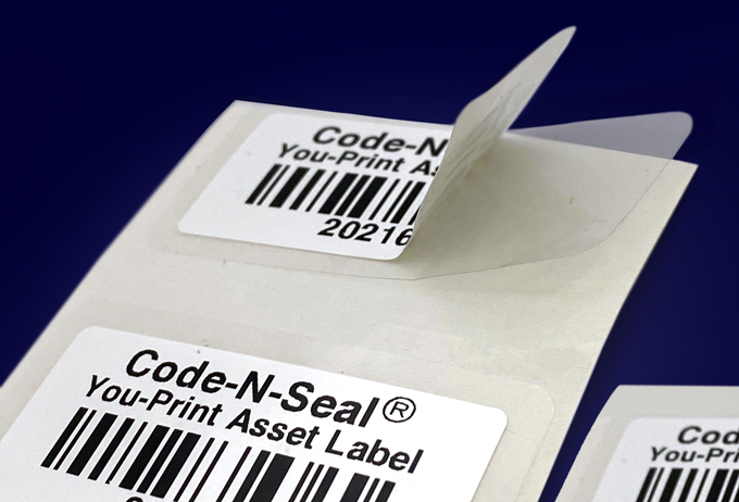 Close up self laminating label construction on liner in front of dark blue background