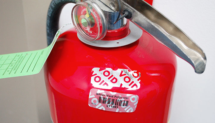 Fire Extinguisher with a VOID silver security tamper evident barcode tag