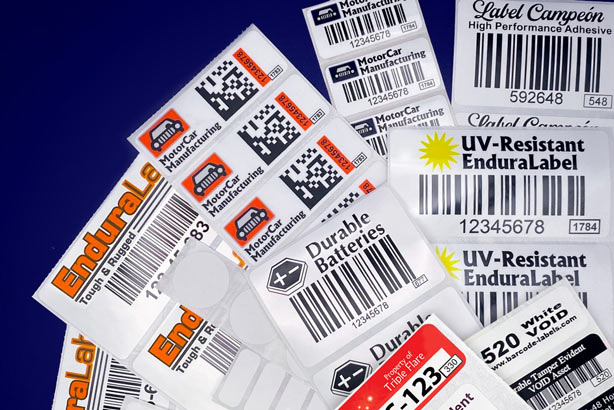 Automotive oem custom printed and blank labels laid out in front of dark blue background