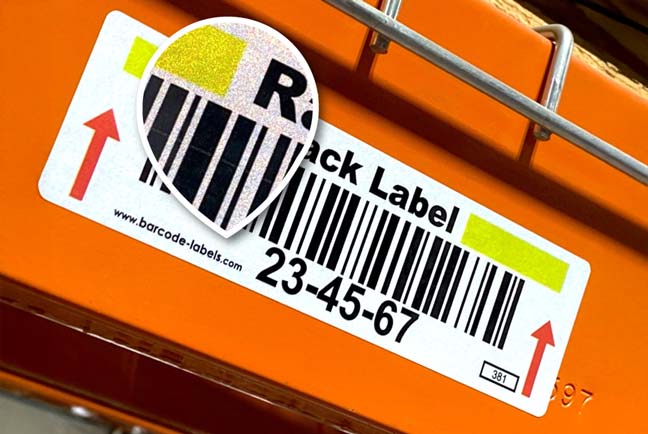 Retro reflective rack label applied over orange rack with a closeup of the textured reflective surface