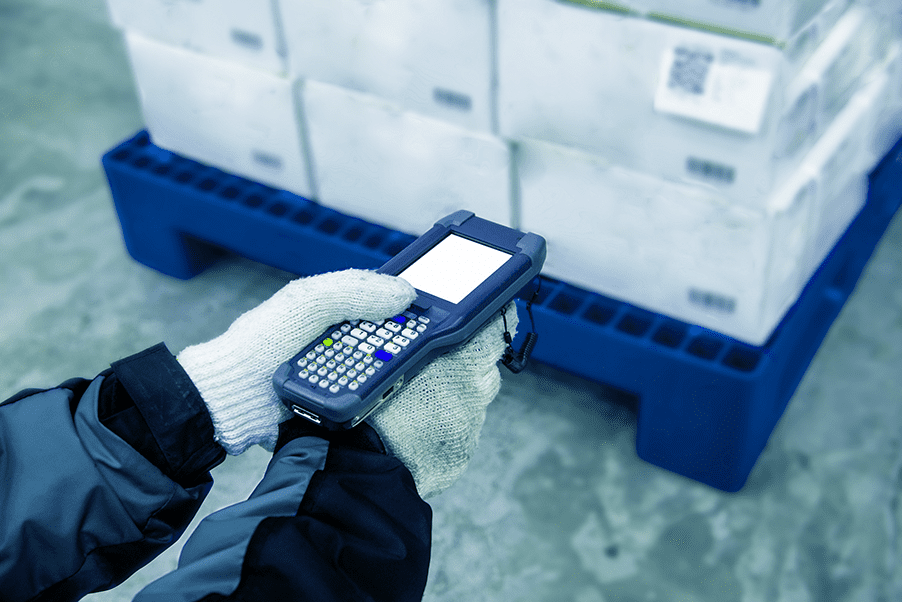 Barcode scanner scanning barcode labeled items on a cold temperature warehouse pallet
