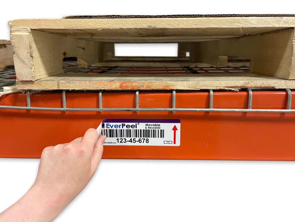 EverPeel removable and reusable label being peeled off of a magnetic warehouse rack