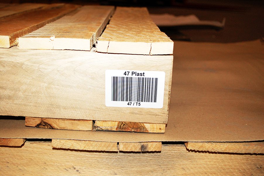 barcode labeled wooden pallet in a warehouse