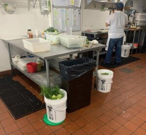 Waterproof asset labels on buckets in a kitchen