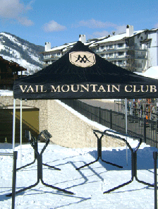Black pop-up tent with "Vail Mountain Club" and Vail mountain logo with ski slope in the background