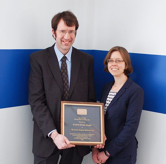 Alex Henkel and Heather Bell pose with TLMI Award