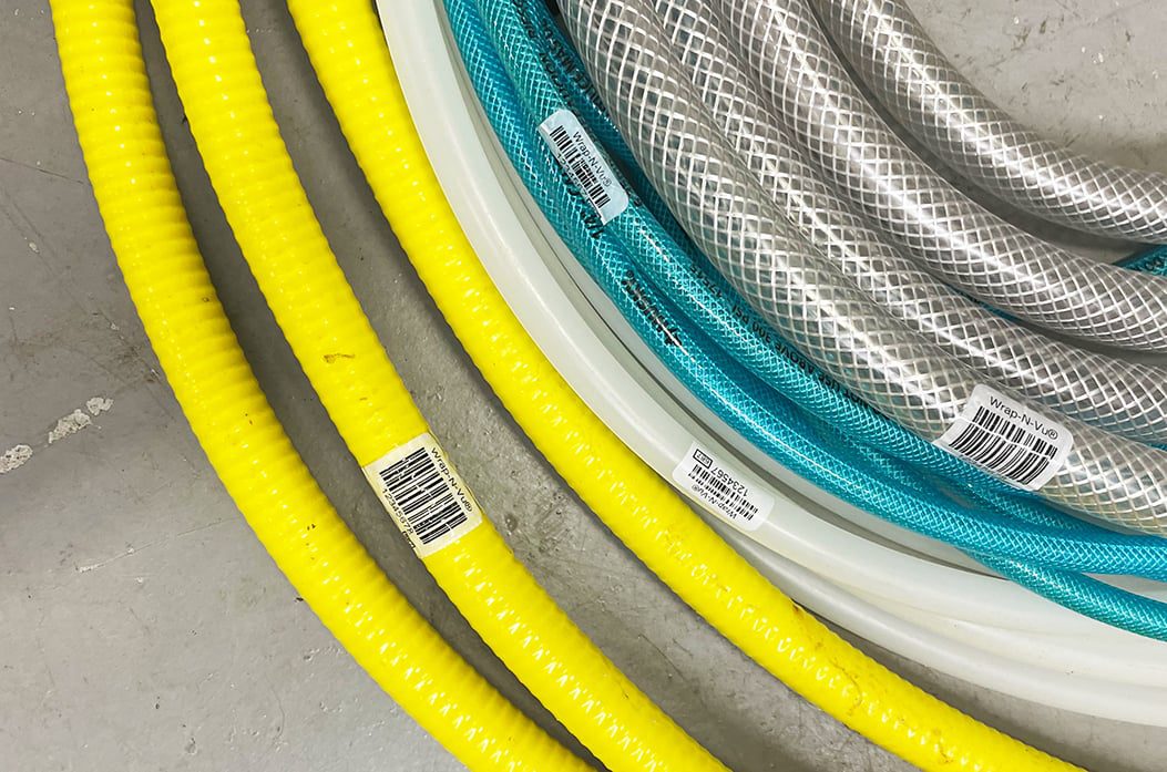 barcode labeled hoses on a warehouse floor