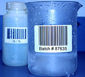 Glass laboratory cylinders with white barcoded freezer labels 