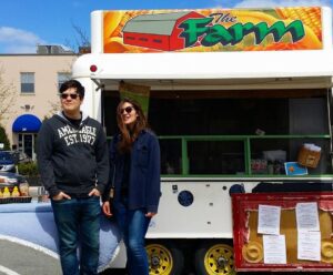 Joey Cocivera with girlfriend posing in front of The Farm Concessions vegetarian/vegan food truck