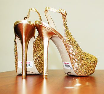 Gold colored high heels with labels 