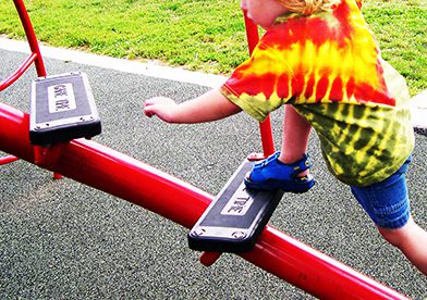 child stepping on rubber playground equipment stairs 
