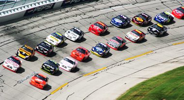 Professional race cars racing down a track 