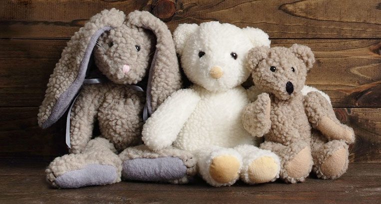 two stuffed bears and one stuffed bunny rabbit