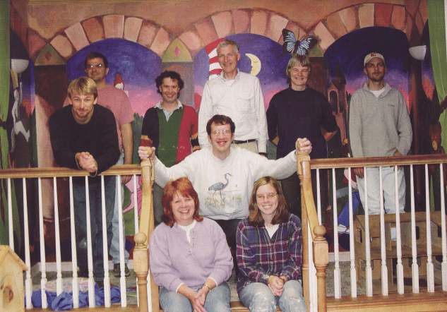 Group of label experts standing in front of a painted wall