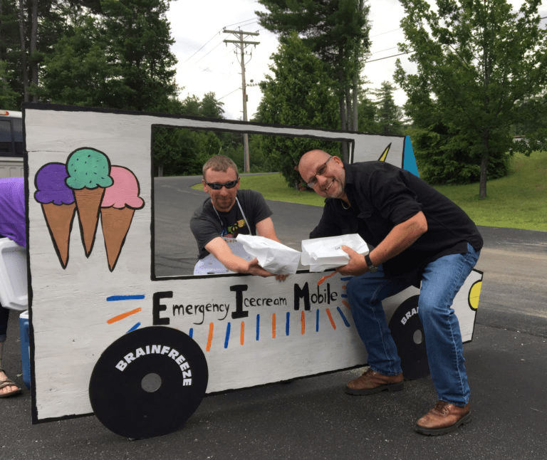 Two label experts next to 'Emergency Ice cream Mobile' cardboard cut out