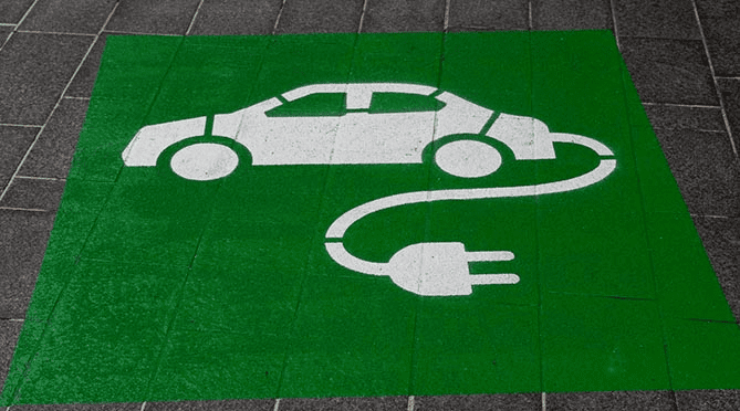 white painting of electric vehicle on a green square background