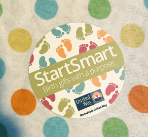 StartSmart sticker with colorful baby foot background