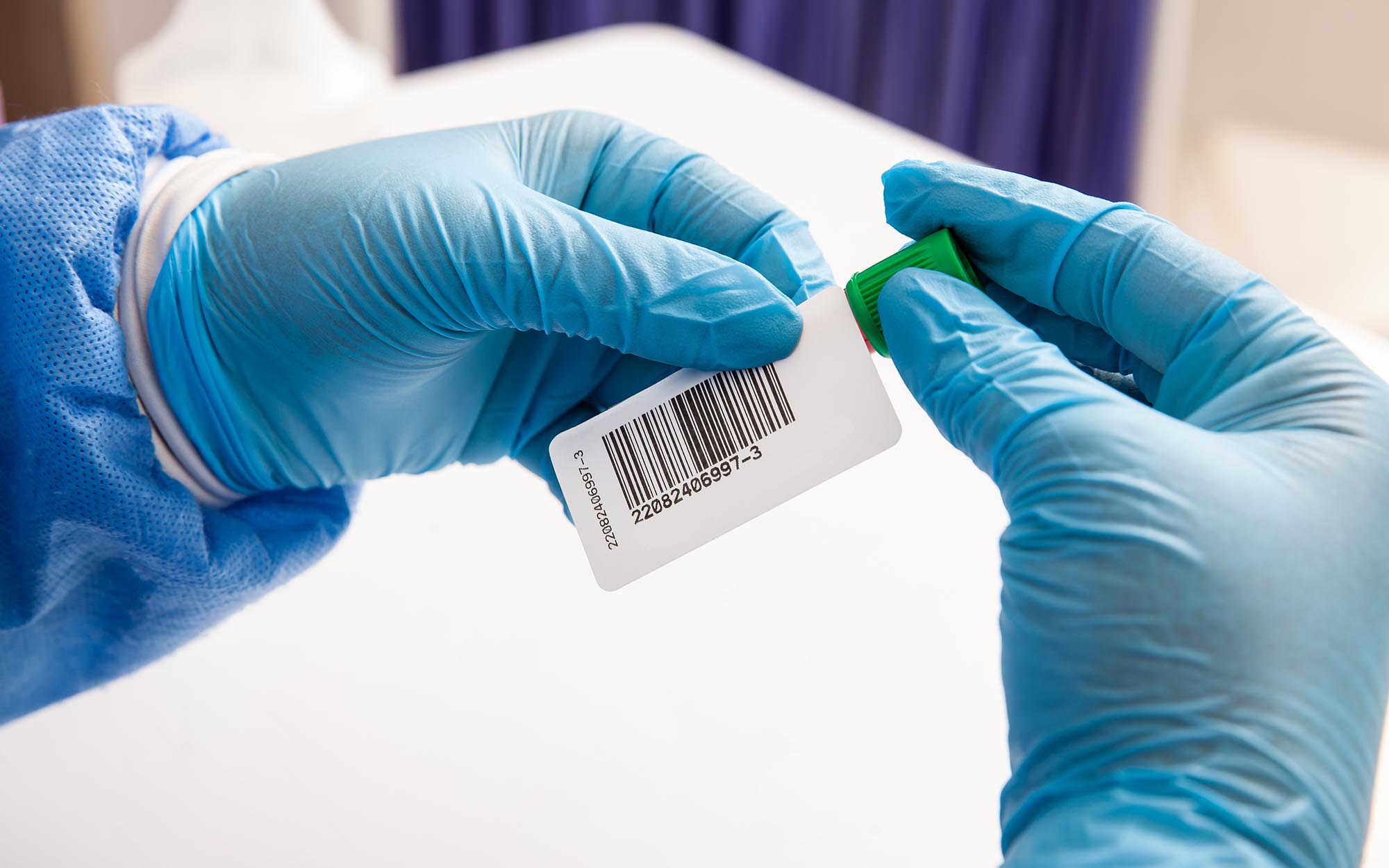 Person putting label on laboratory sample