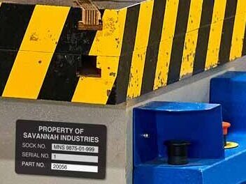 Industrial punching press machine labeled with a part number label.