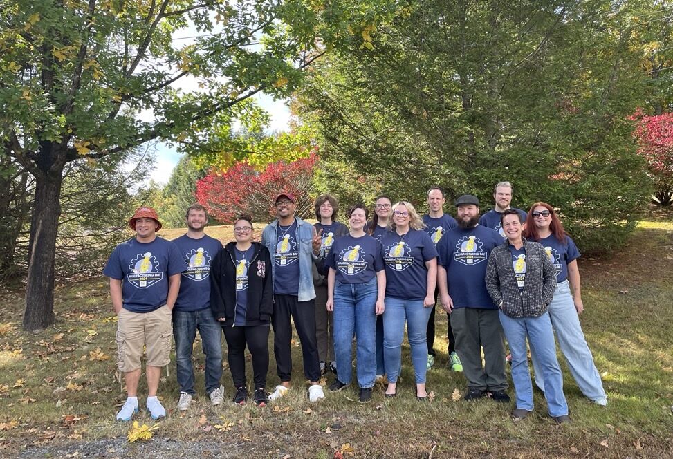 Label Experts standing outside wearing 'Manufacturing Day 2024' blue shirts