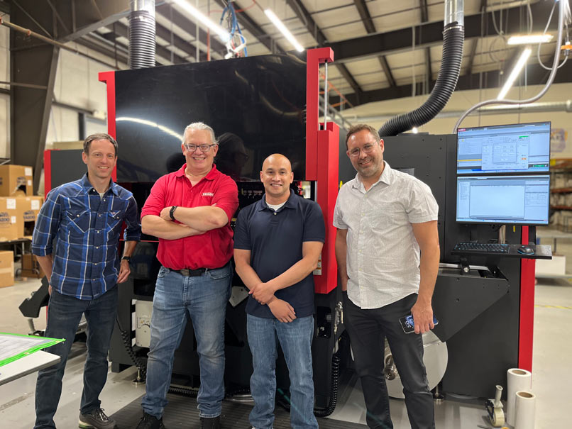 Juan Munoz posed in front of Xeikon industrial printer