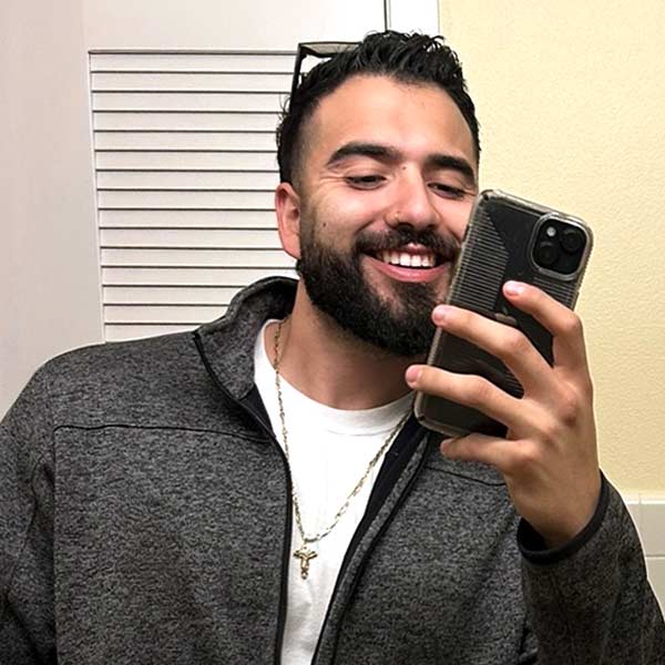 Label Expert Jesus Mendoza taking an iPhone selfie in front of a mirror.
