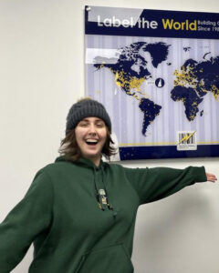 EIM intern in front of a map