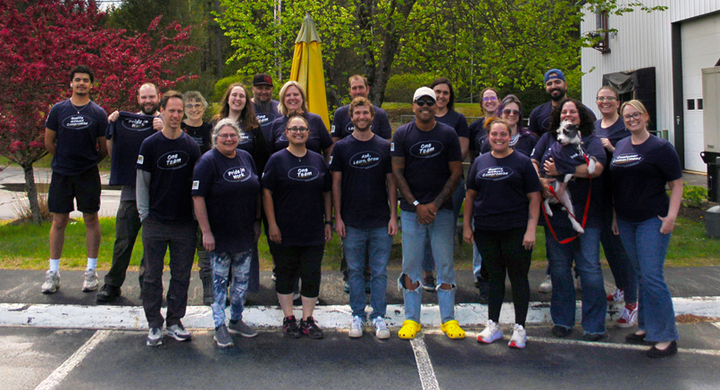 EIM Label Experts outside wearing shirts with company values printed on